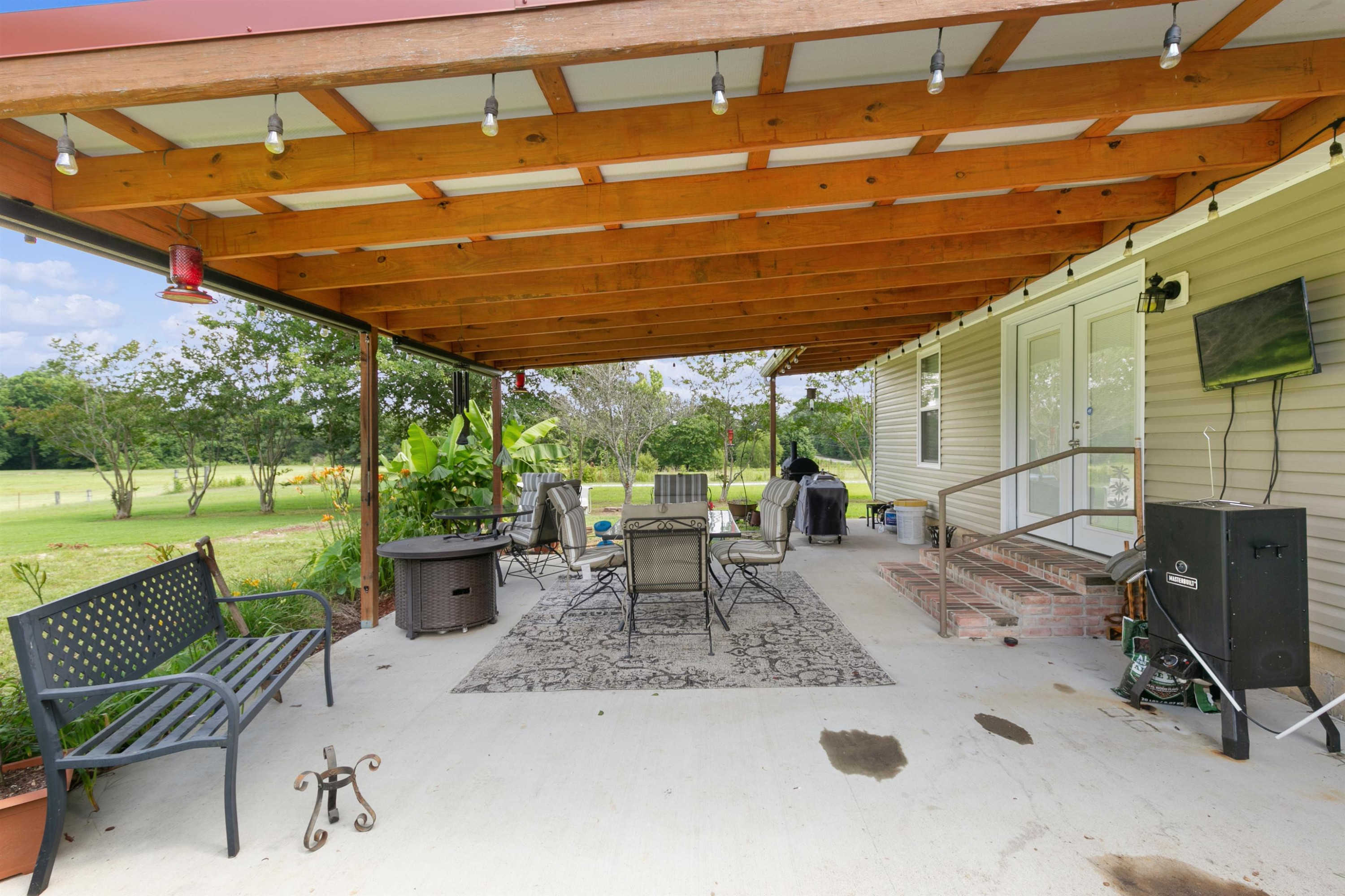 3225 Pickens Store Road Mason, TN 38049 - Photo 4 of 32 a view of a patio with a table chairs and a backyard