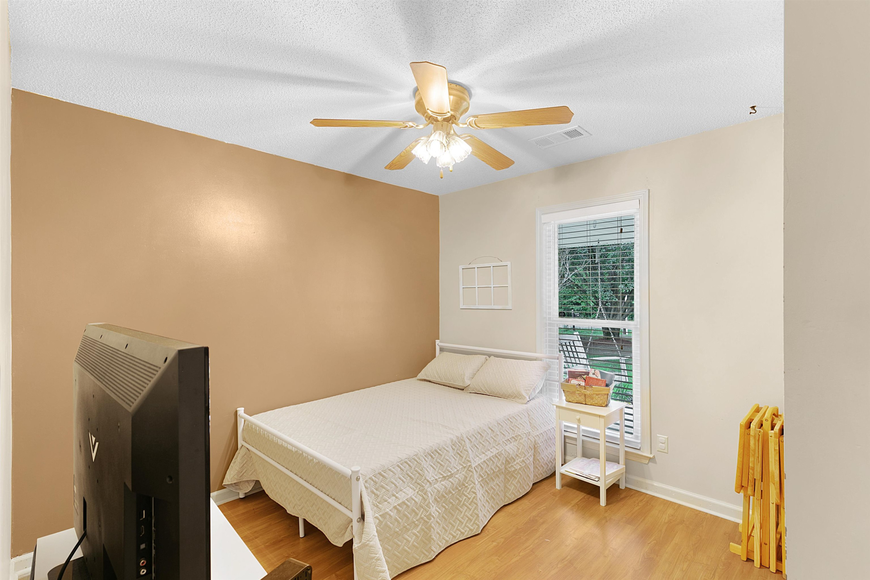 3225 Pickens Store Road Mason, TN 38049 - Photo 6 of 32 a bedroom with a bed and a chandelier