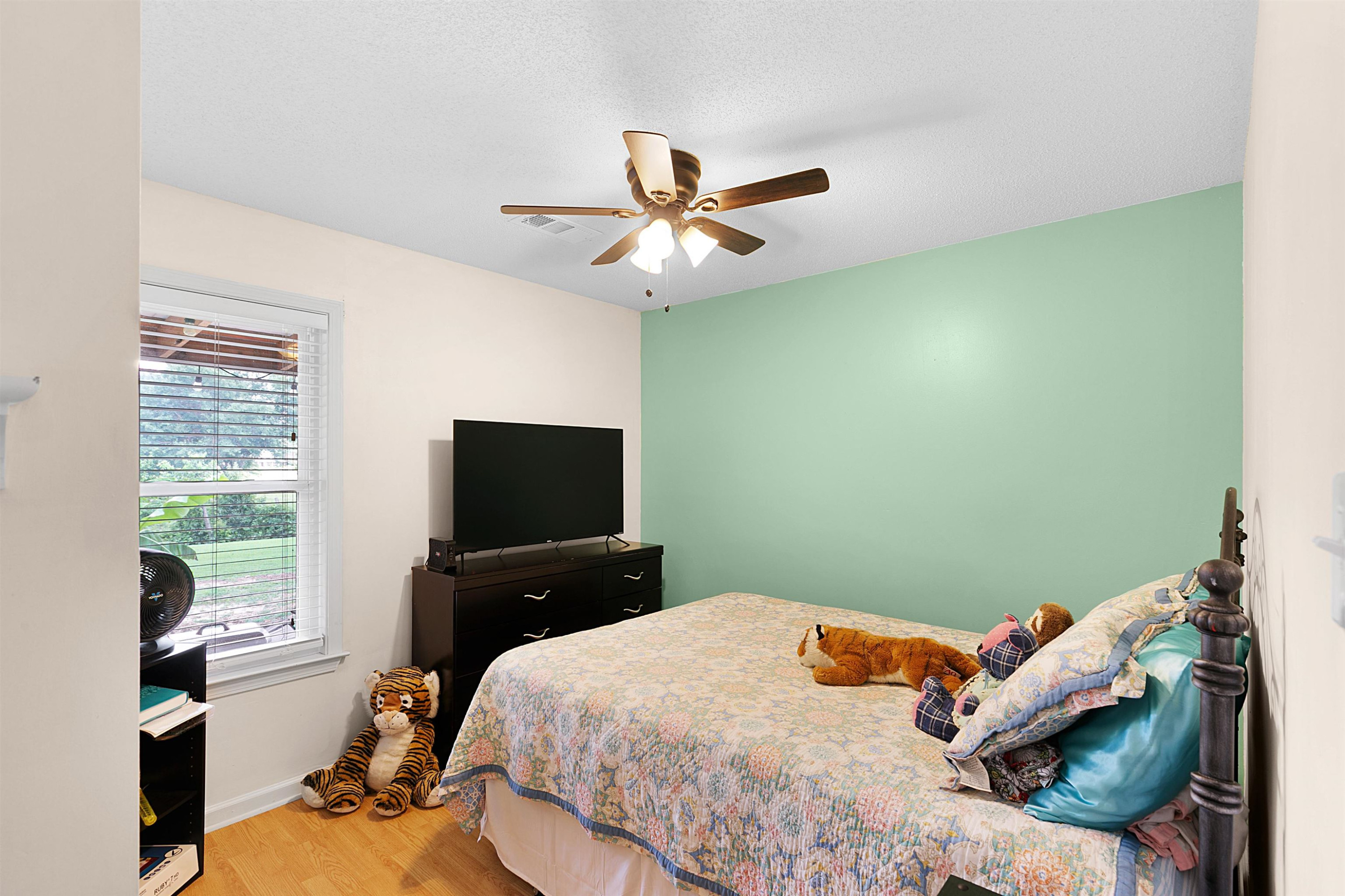 3225 Pickens Store Road Mason, TN 38049 - Photo 8 of 32 a bedroom with a bed and a flat tv screen on dresser