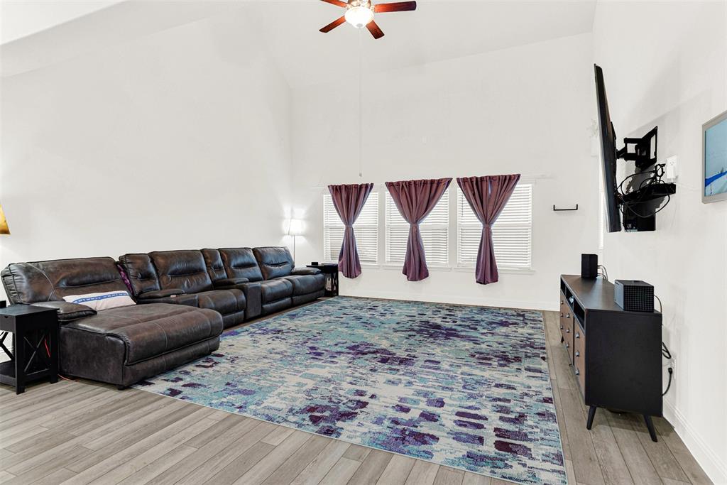 817 Amy Boulevard Anna, TX 75409 - Photo 11 of 40 a living room with couches rug and a wall painting