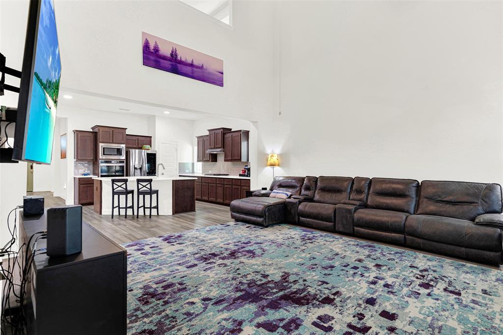 817 Amy Boulevard Anna, TX 75409 - Photo 13 of 40 a living room with furniture wooden floor and a flat screen tv
