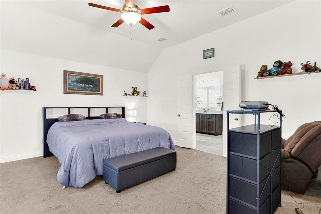 817 Amy Boulevard Anna, TX 75409 - Photo 16 of 40 a spacious bedroom with a bed and dresser