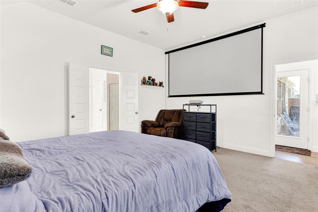 817 Amy Boulevard Anna, TX 75409 - Photo 17 of 40 a bedroom with a bed and a flat screen tv