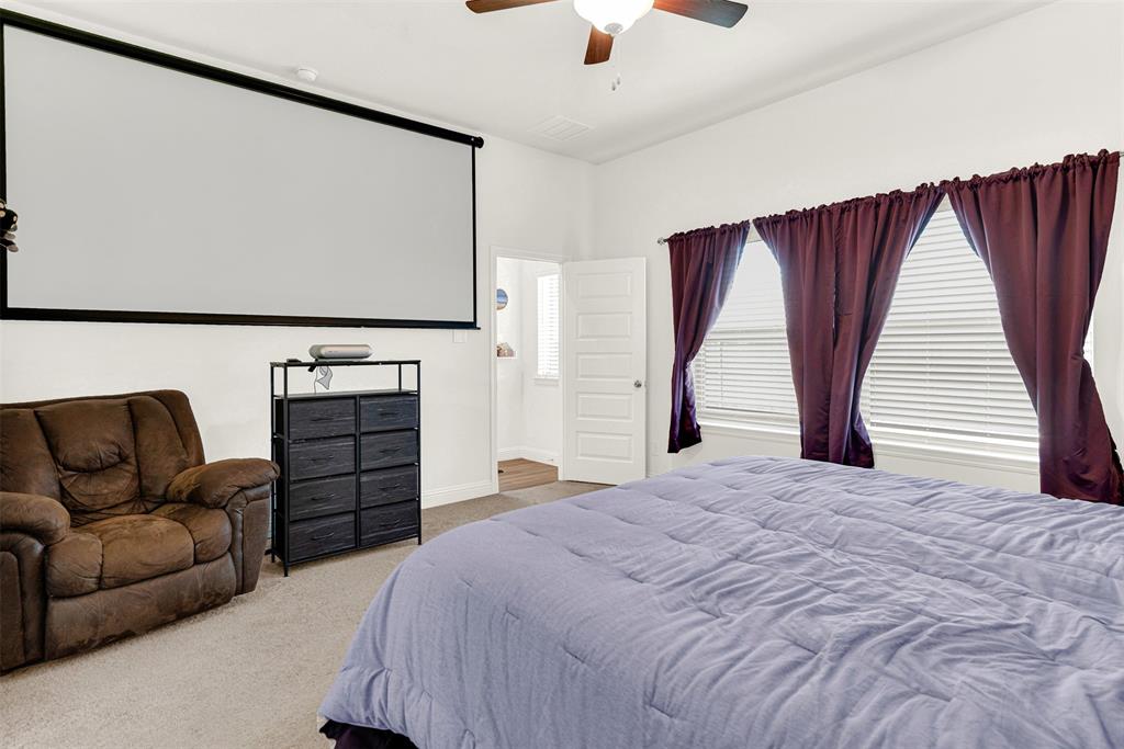 817 Amy Boulevard Anna, TX 75409 - Photo 18 of 40 a bedroom with a bed and a couch