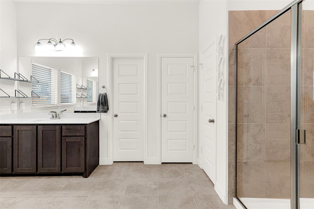 817 Amy Boulevard Anna, TX 75409 - Photo 19 of 40 a bathroom with a sink vanity and mirror