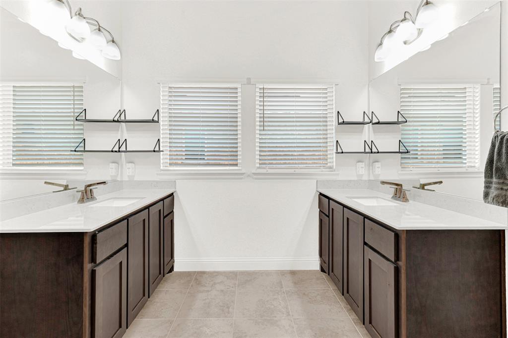 817 Amy Boulevard Anna, TX 75409 - Photo 20 of 40 a kitchen with a sink a window and cabinets