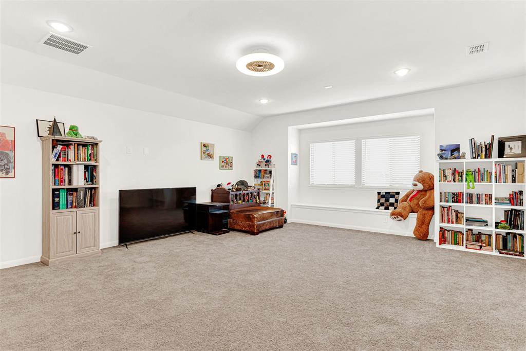 817 Amy Boulevard Anna, TX 75409 - Photo 26 of 40 a living room with furniture and a book shelf