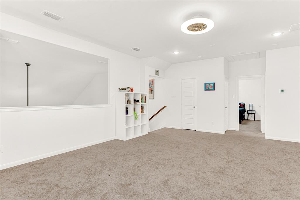 817 Amy Boulevard Anna, TX 75409 - Photo 28 of 40 a view of a livingroom with wooden floor and a ceiling fan