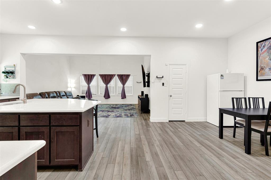 817 Amy Boulevard Anna, TX 75409 - Photo 5 of 40 a hallway view with furniture a wooden floor and white walls