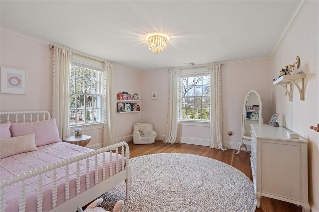 56 Pine Ridge Road Newton, MA 02468 - Photo 12 of 24 a bedroom with a bed and a chandelier