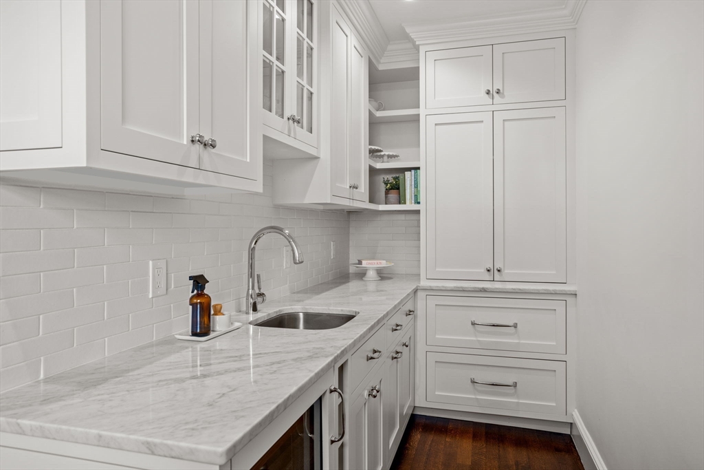 56 Pine Ridge Road Newton, MA 02468 - Photo 16 of 24 a kitchen with white cabinets and sink