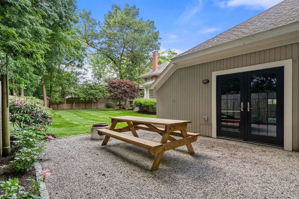 56 Pine Ridge Road Newton, MA 02468 - Photo 23 of 24 a park bench sitting in the middle of a garden