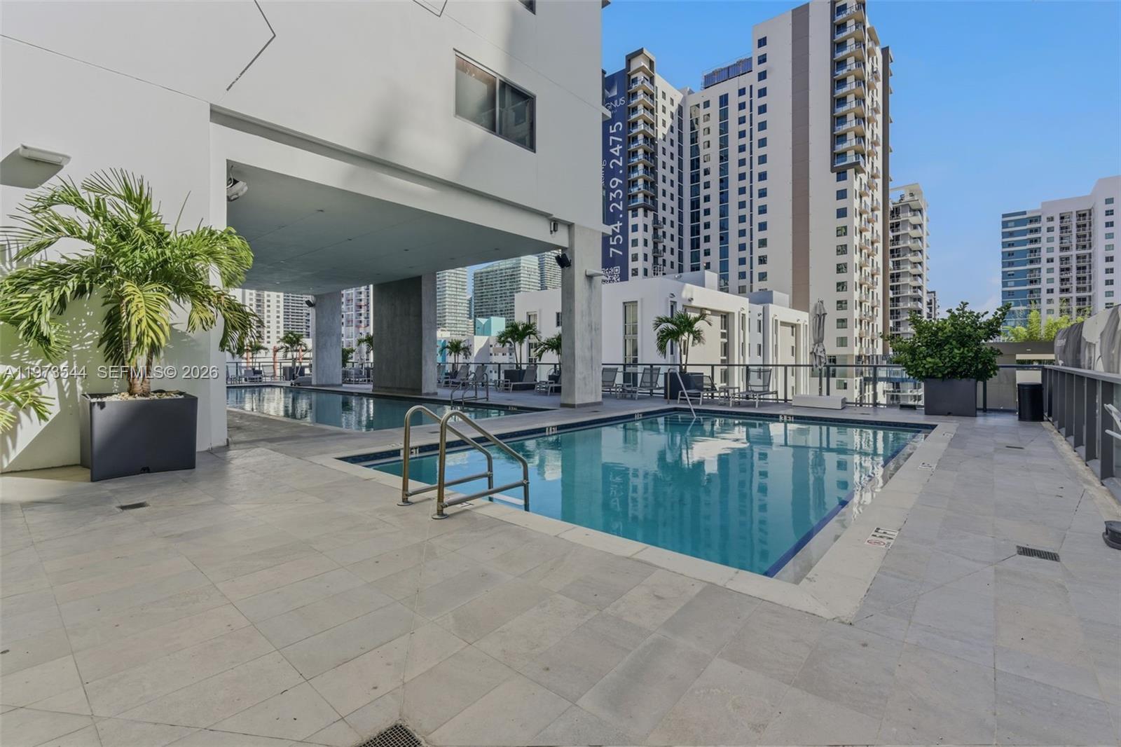 229 Southwest 9th Street, Unit 407 Miami, FL 33130 - Photo 3 of 29 a swimming pool with outdoor seating and yard