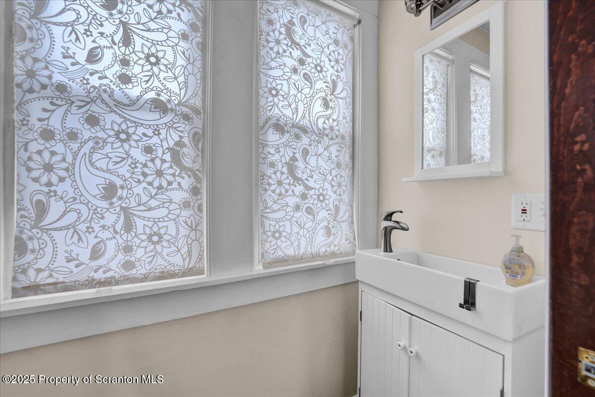 Undisclosed Address Scranton, PA 18509 - Photo 12 of 26 a bathroom with a sink and a mirror
