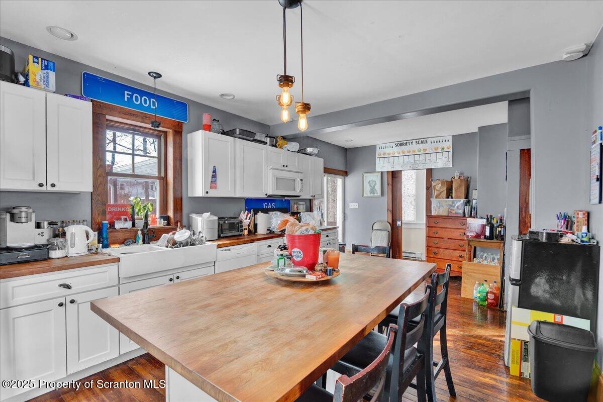 Undisclosed Address Scranton, PA 18509 - Photo 4 of 26 a kitchen with stainless steel appliances wooden floor dining table and chairs