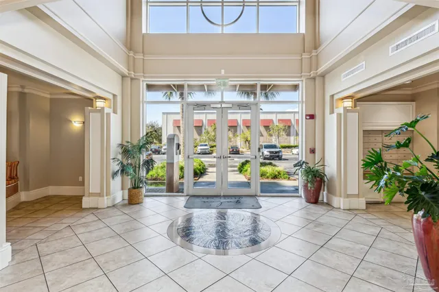 a living room with furniture and a floor to ceiling window