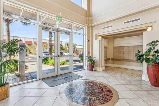 a living room with furniture and a large window with balcony view