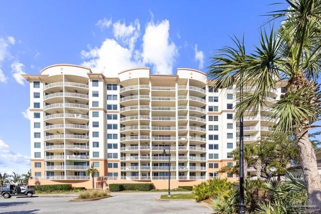 a kitchen with granite countertop a refrigerator stove top oven a sink and dishwasher wooden cabinets