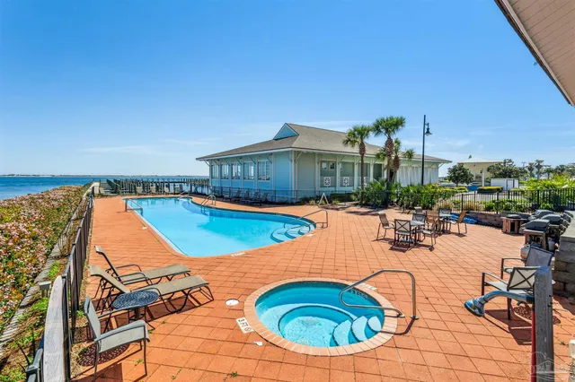 an outdoor space with swimming pool and furniture