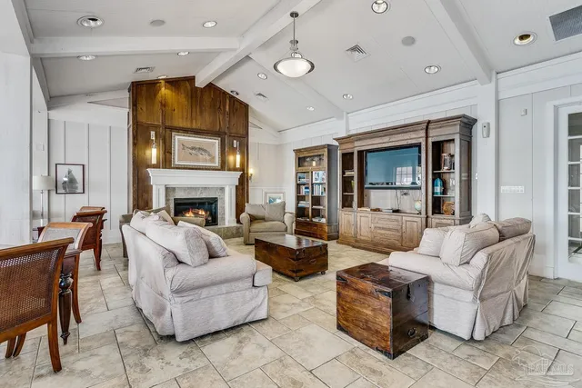 a living room with furniture and floor to ceiling windows