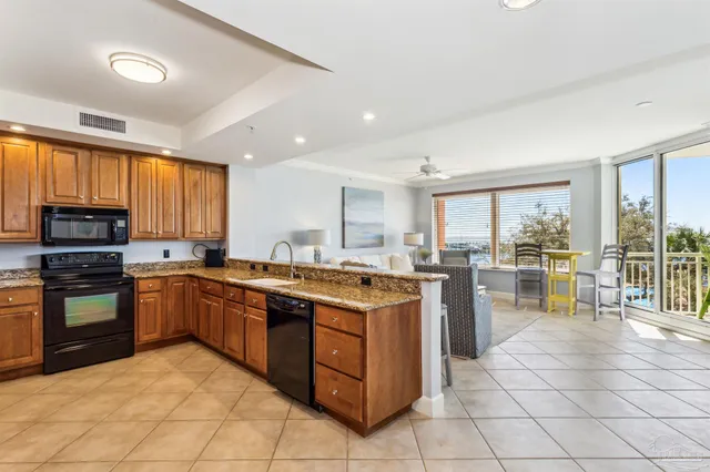 a kitchen with a stove sink and cabinets