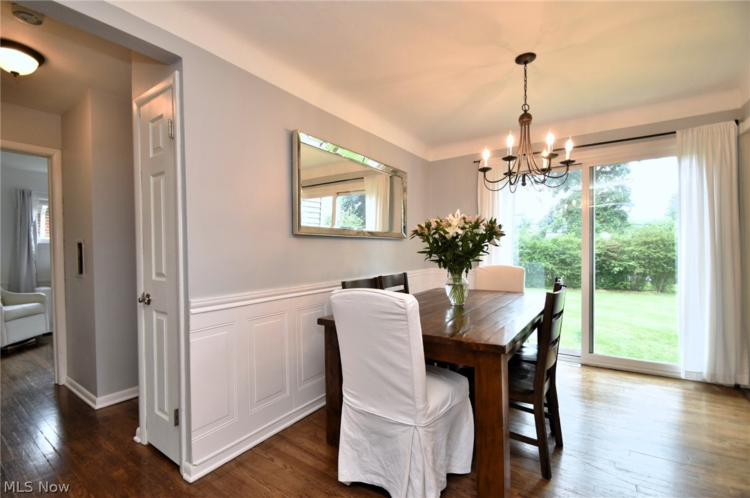 1174 Haverston Road Cleveland, OH 44124 - Photo 6 of 21 Dining area featuring a healthy amount of sunlight, an inviting chandelier, and dark hardwood / wood-style floors
