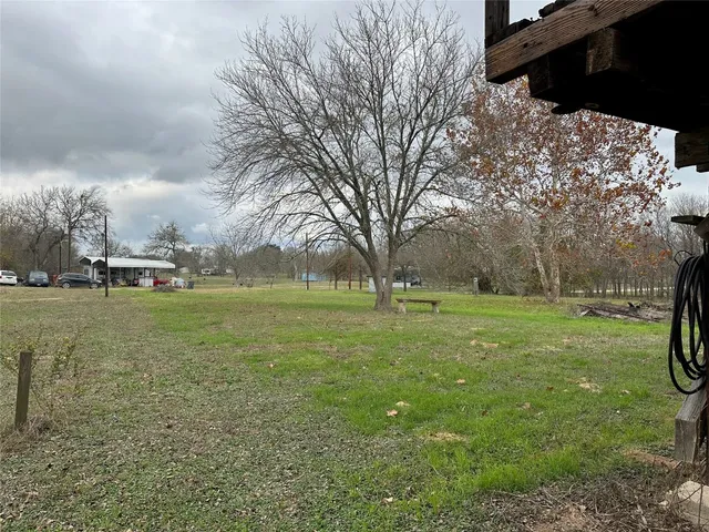 a view of a field of grass and trees