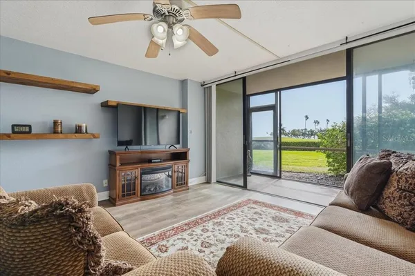 a living room with furniture and a floor to ceiling window