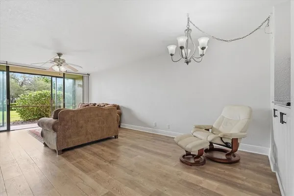 a living room with furniture a window and a chandelier