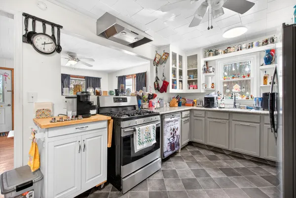 a kitchen with refrigerator and cabinets