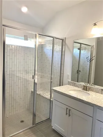 a bathroom with a double vanity sink and mirror