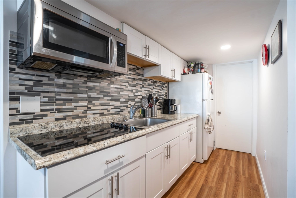 4 Fenley Street, Unit 1 Revere, MA 02151 - Photo 1 of 9 a kitchen with white cabinets and appliances