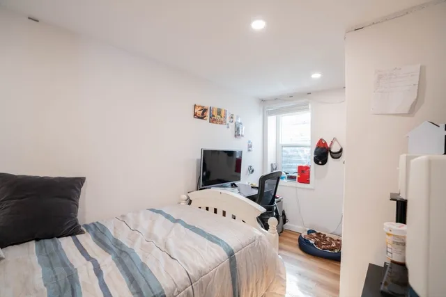 a bedroom with a bed and a window