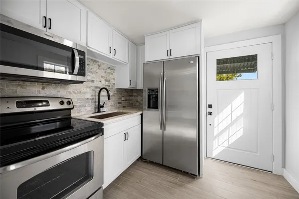 a kitchen with stainless steel appliances and wooden cabinets
