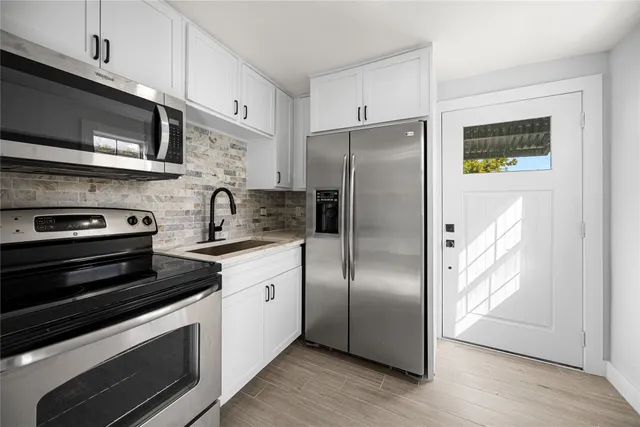 a kitchen with stainless steel appliances and wooden cabinets