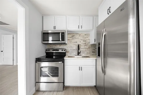 a kitchen with a stove microwave and refrigerator
