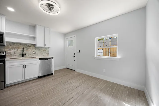 a kitchen with a refrigerator and a stove top oven
