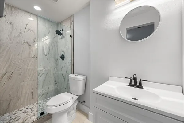 a white toilet sitting next to a bathroom sink