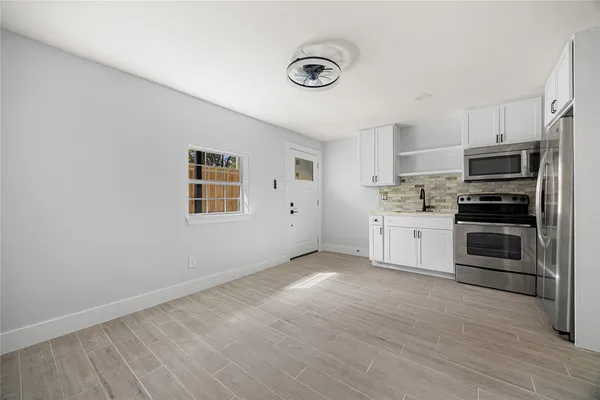 a kitchen with stainless steel appliances a refrigerator and a stove top oven