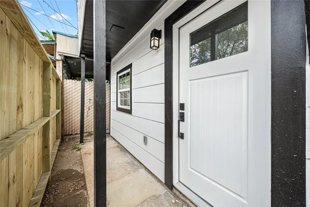 a view of a hallway with wooden floor and windows