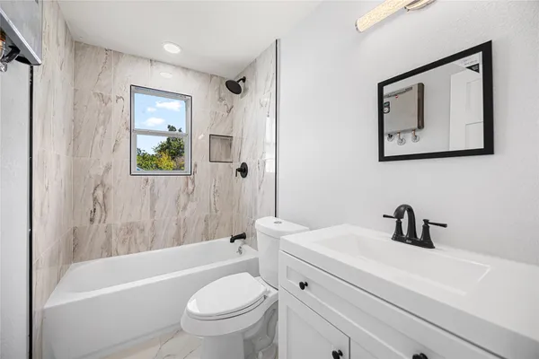 a bathroom with a sink a toilet and bathtub
