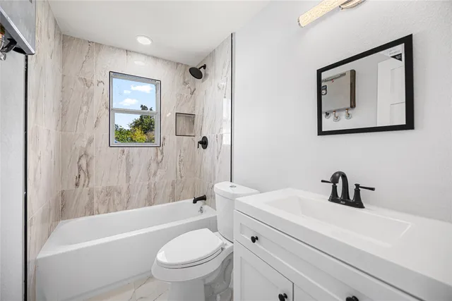 a bathroom with a sink a toilet and bathtub