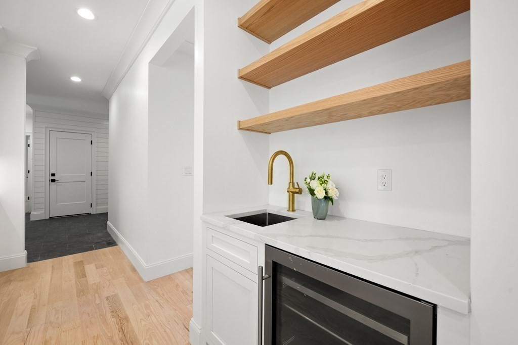 22 Suffolk Road Wellesley, MA 02481 - Photo 11 of 39 a kitchen with a sink and a refrigerator