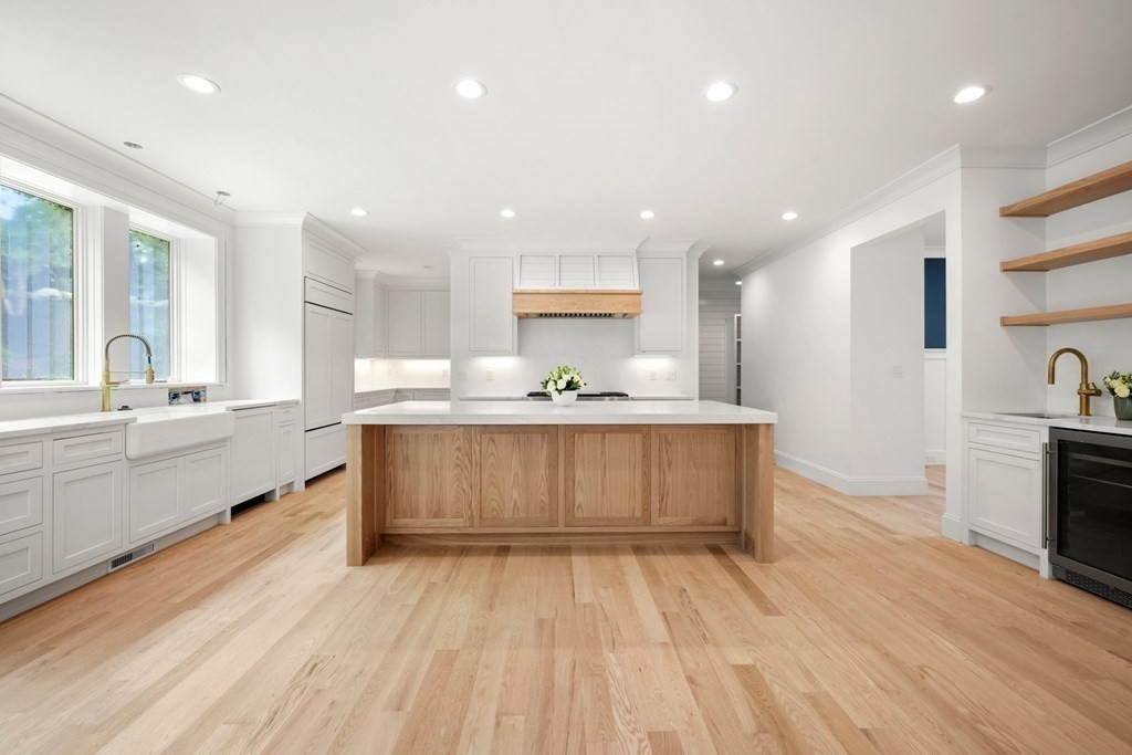 22 Suffolk Road Wellesley, MA 02481 - Photo 13 of 39 a large white kitchen with kitchen island a sink stainless steel appliances and cabinets