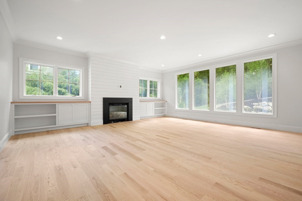 22 Suffolk Road Wellesley, MA 02481 - Photo 17 of 39 a view of an empty room with a fireplace and a window