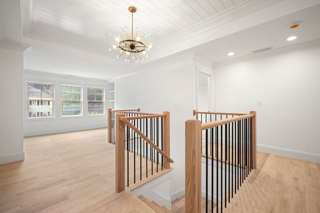 22 Suffolk Road Wellesley, MA 02481 - Photo 20 of 39 a view of a hallway with windows and chandelier