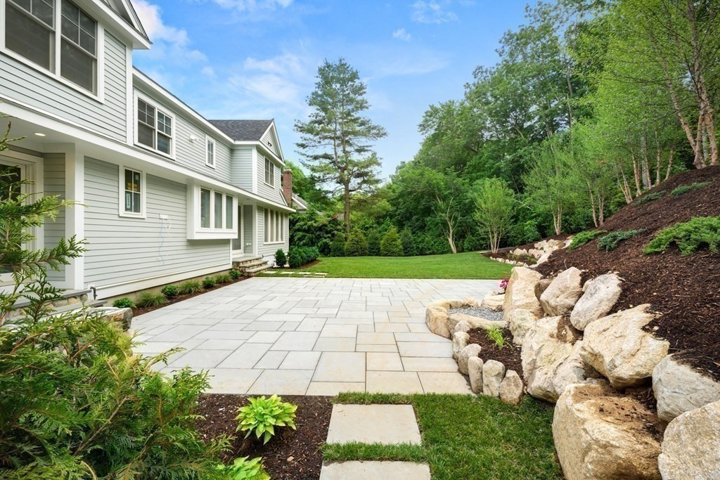 22 Suffolk Road Wellesley, MA 02481 - Photo 32 of 39 a white house with a yard and a large tree
