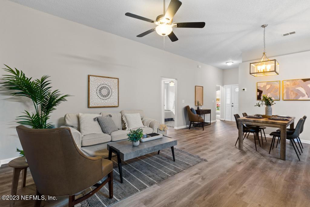 1652 Spring Oaks Lane Jacksonville, FL 32221 - Photo 11 of 37 a living room with furniture a window and a chandelier