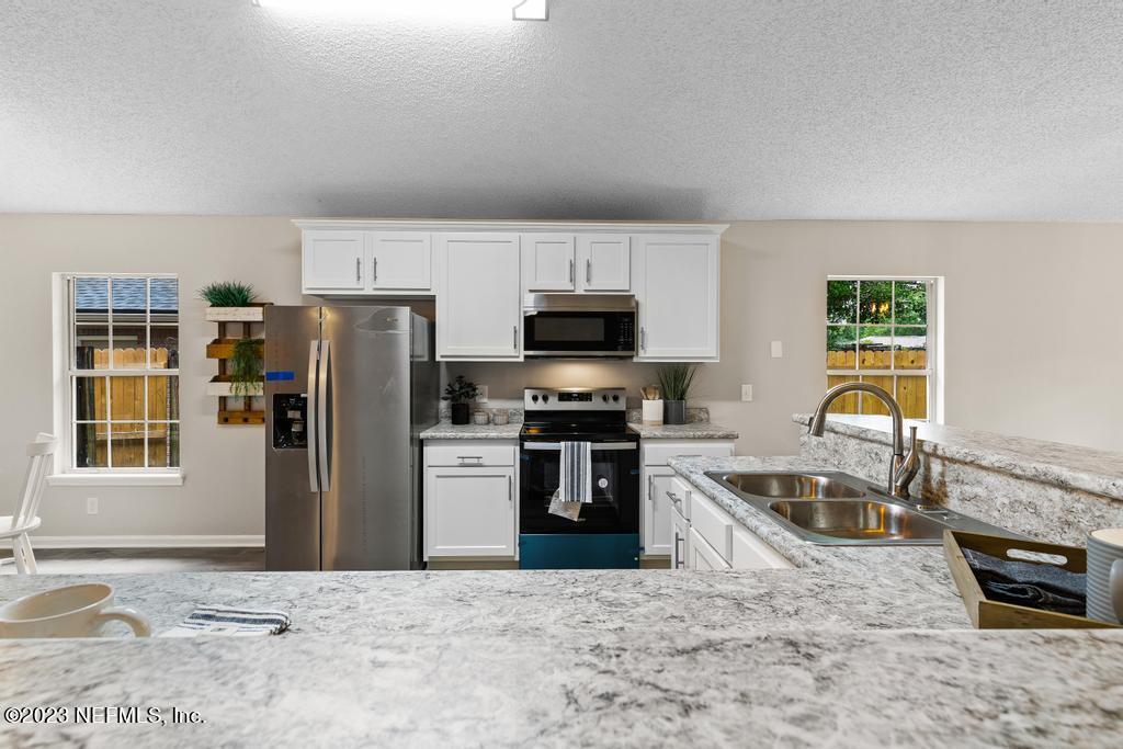 1652 Spring Oaks Lane Jacksonville, FL 32221 - Photo 14 of 37 a kitchen with a refrigerator stove and microwave