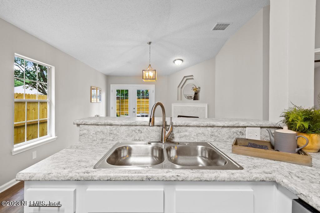 1652 Spring Oaks Lane Jacksonville, FL 32221 - Photo 17 of 37 a kitchen with granite countertop a sink and a window